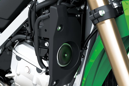 Closeup detail of a motorcycle staged in a white studio background. opens in a new window