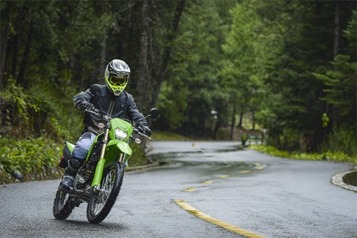 Front angle of a person riding a motorcycle on a highway. opens in a new window