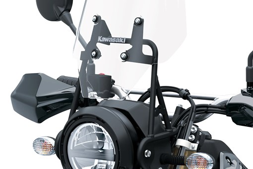 Headlight of a motorcycle staged in a white studio background. opens in a new window