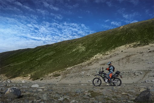 Side angle of a person riding a motorcycle off-road. opens in a new window