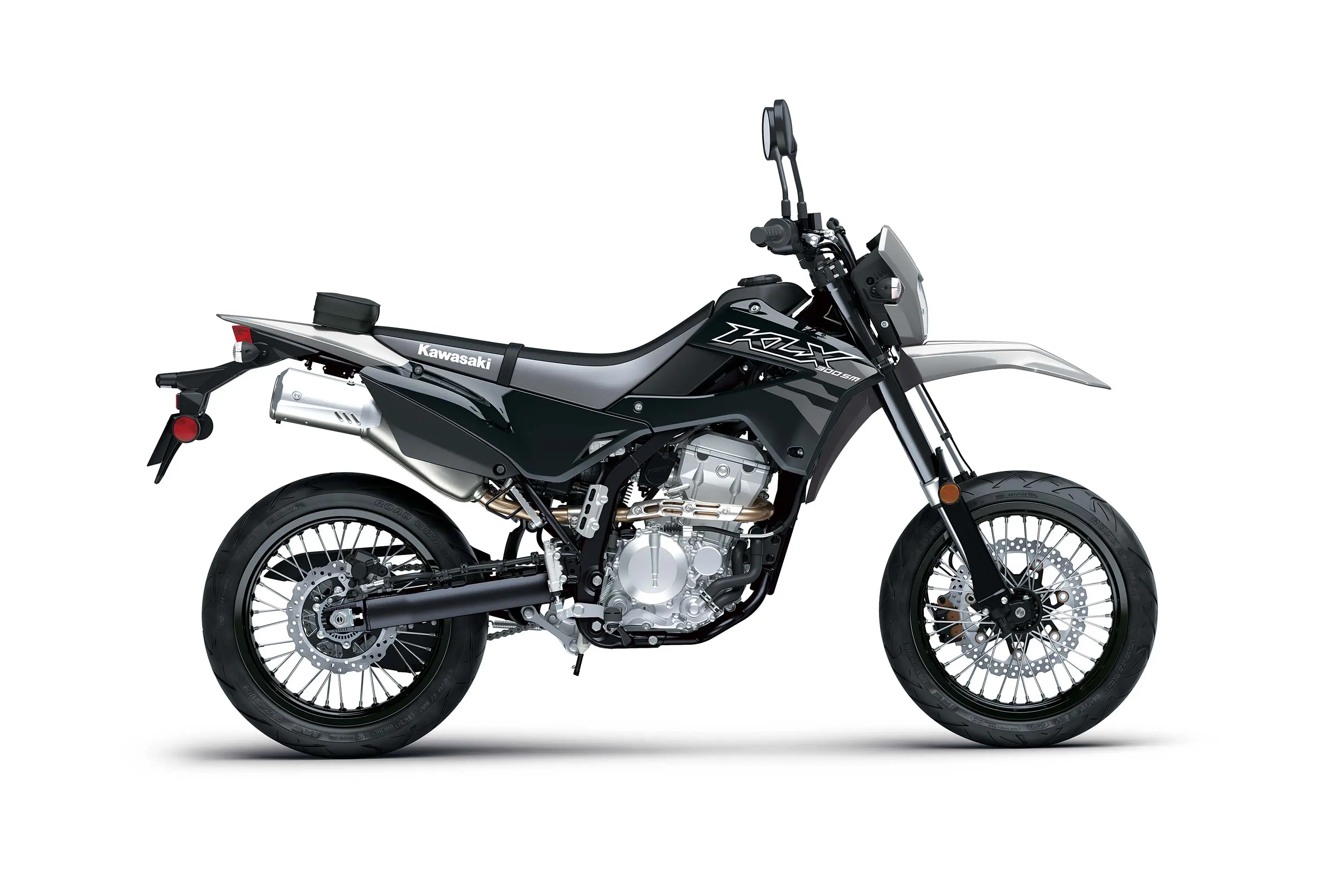 Profile angle of a grey motorcycle staged in a white studio background.