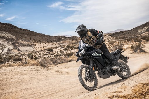 Three-quarter front angle of a person riding a motorcycle off-road. opens in a new window