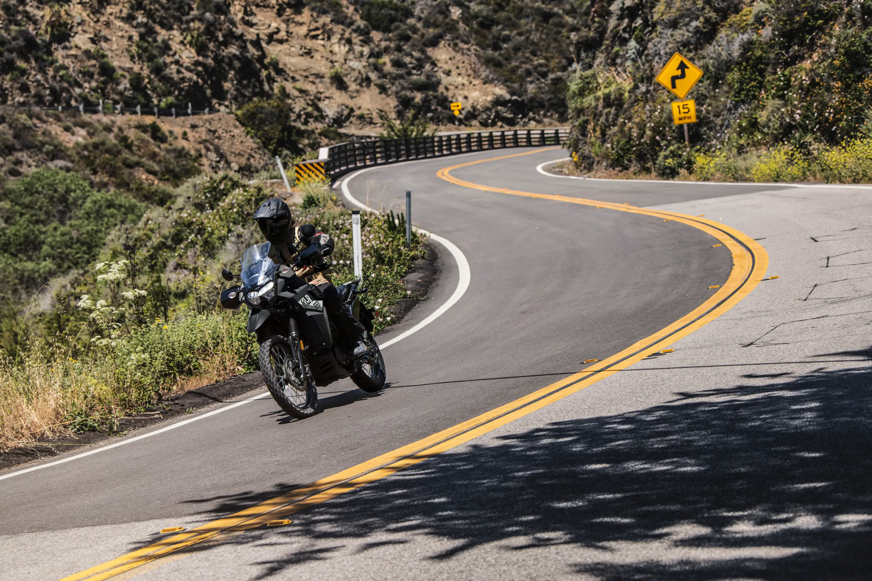 Front angle of a person riding a motorcycle on a highway.