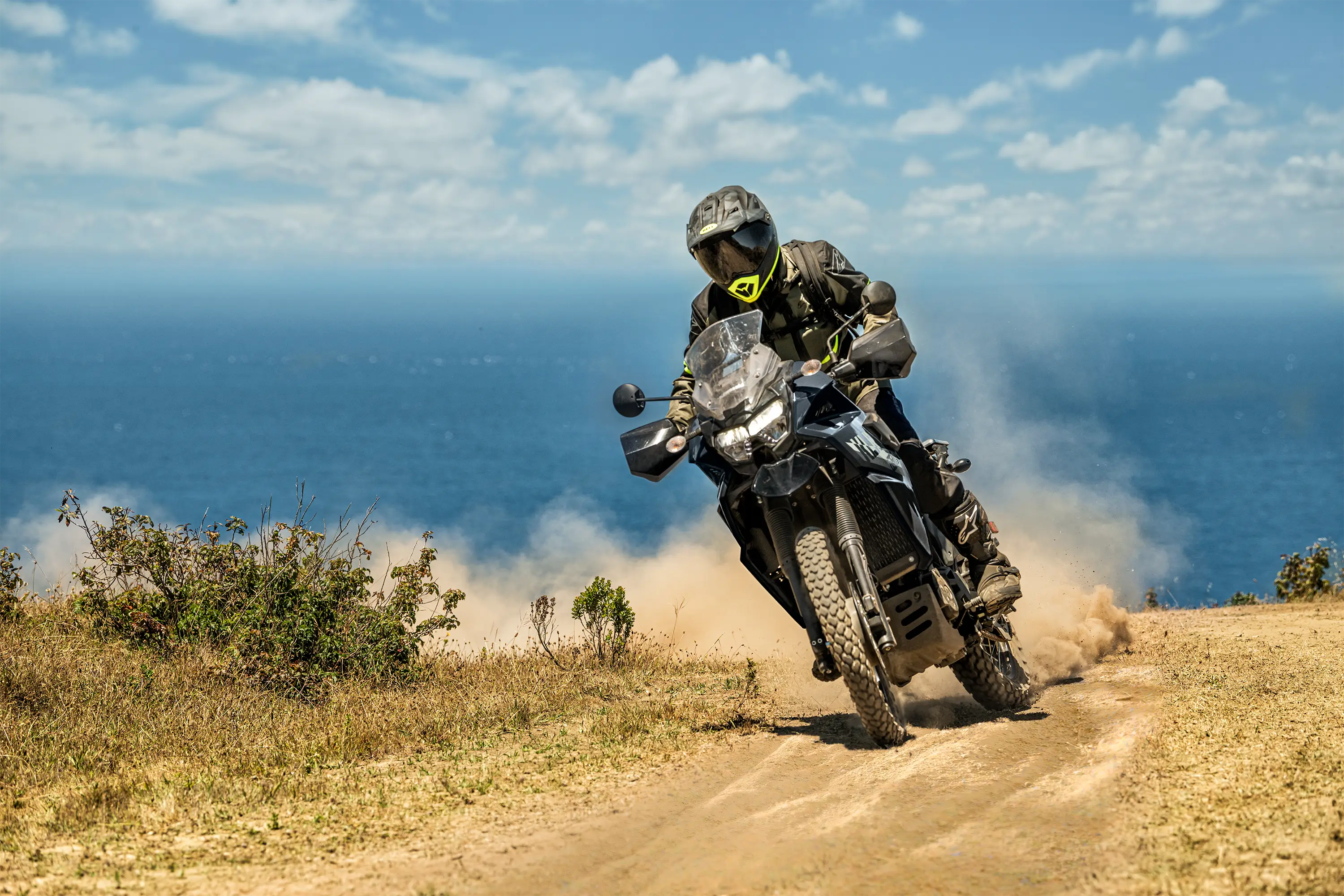 Three-quarter front angle of a person riding a motorcycle off-road.