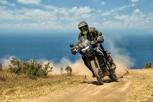Three-quarter front angle of a person riding a motorcycle off-road. opens in a new window