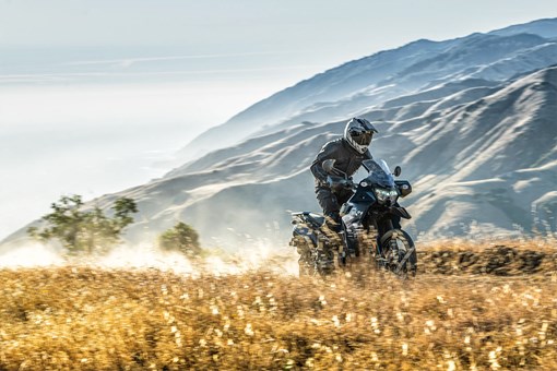 Three-quarter front low down angle of a person riding a motorcycle off-road. opens in a new window