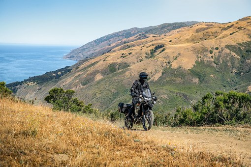 Side angle of a person riding a motorcycle off-road. opens in a new window