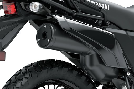 Exhaust of a motorcycle staged in a white studio background. opens in a new window