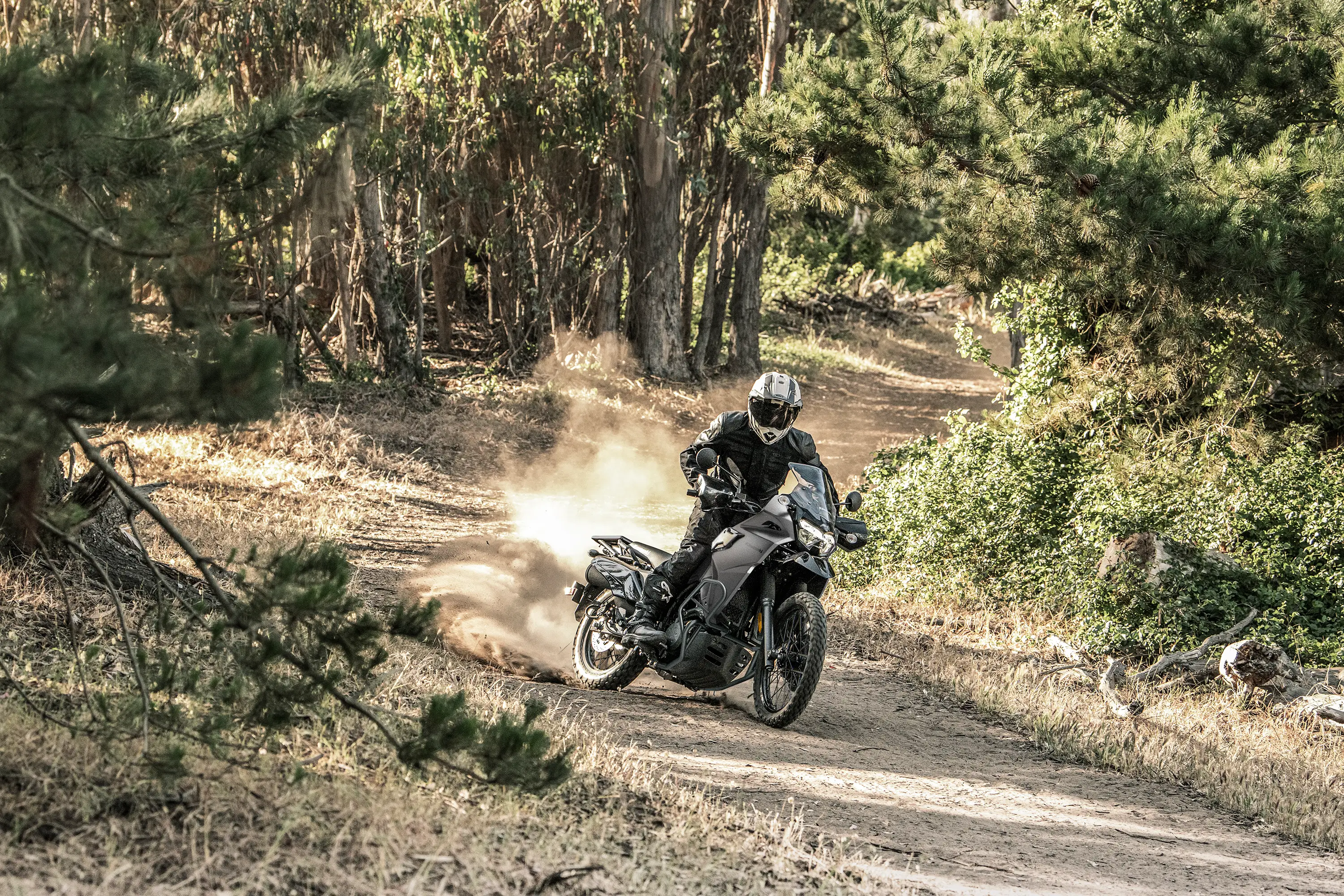 Three-quarter front angle of a person riding a motorcycle off-road.