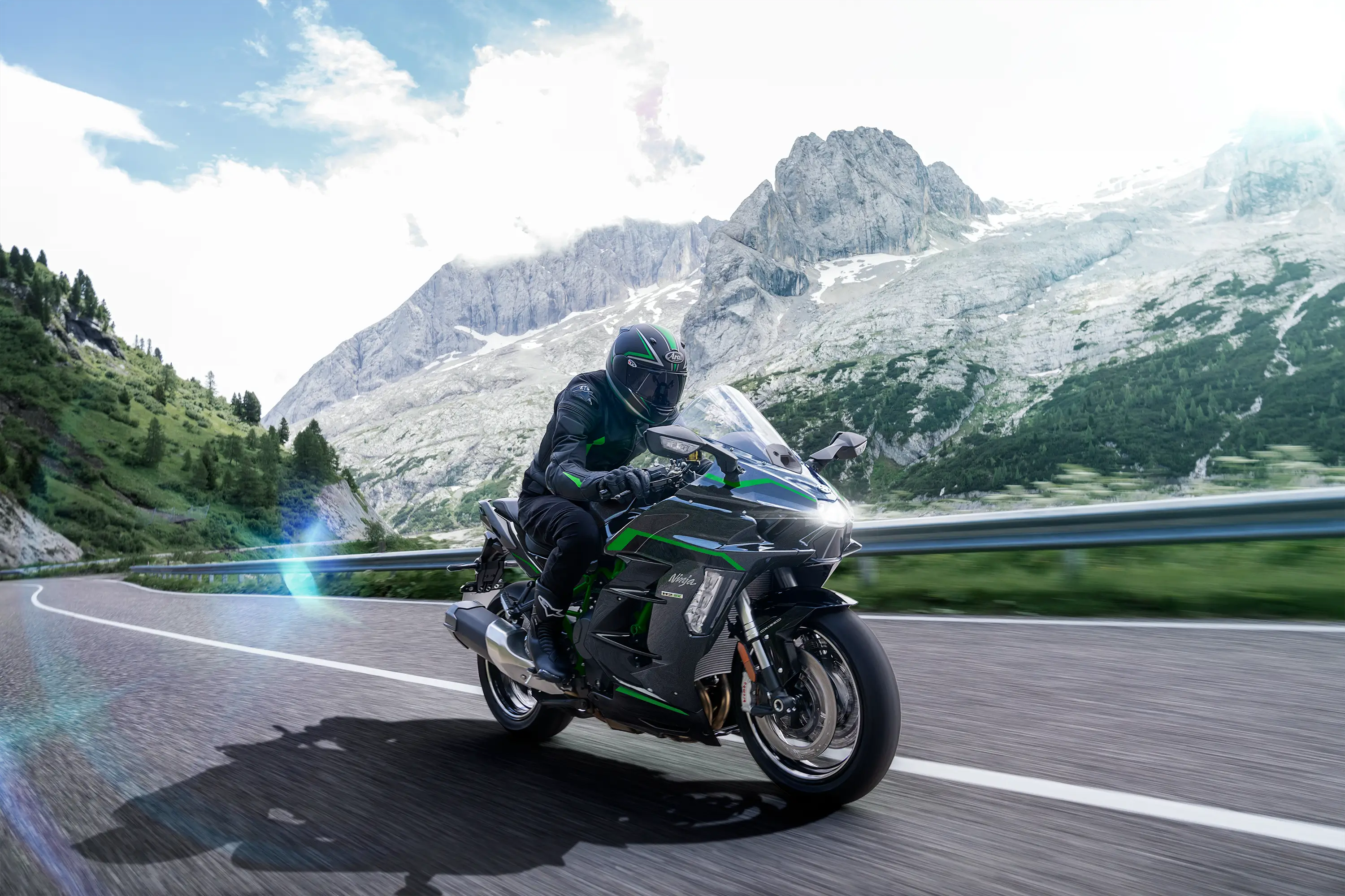 Side angle of a person riding a motorcycle on a highway.