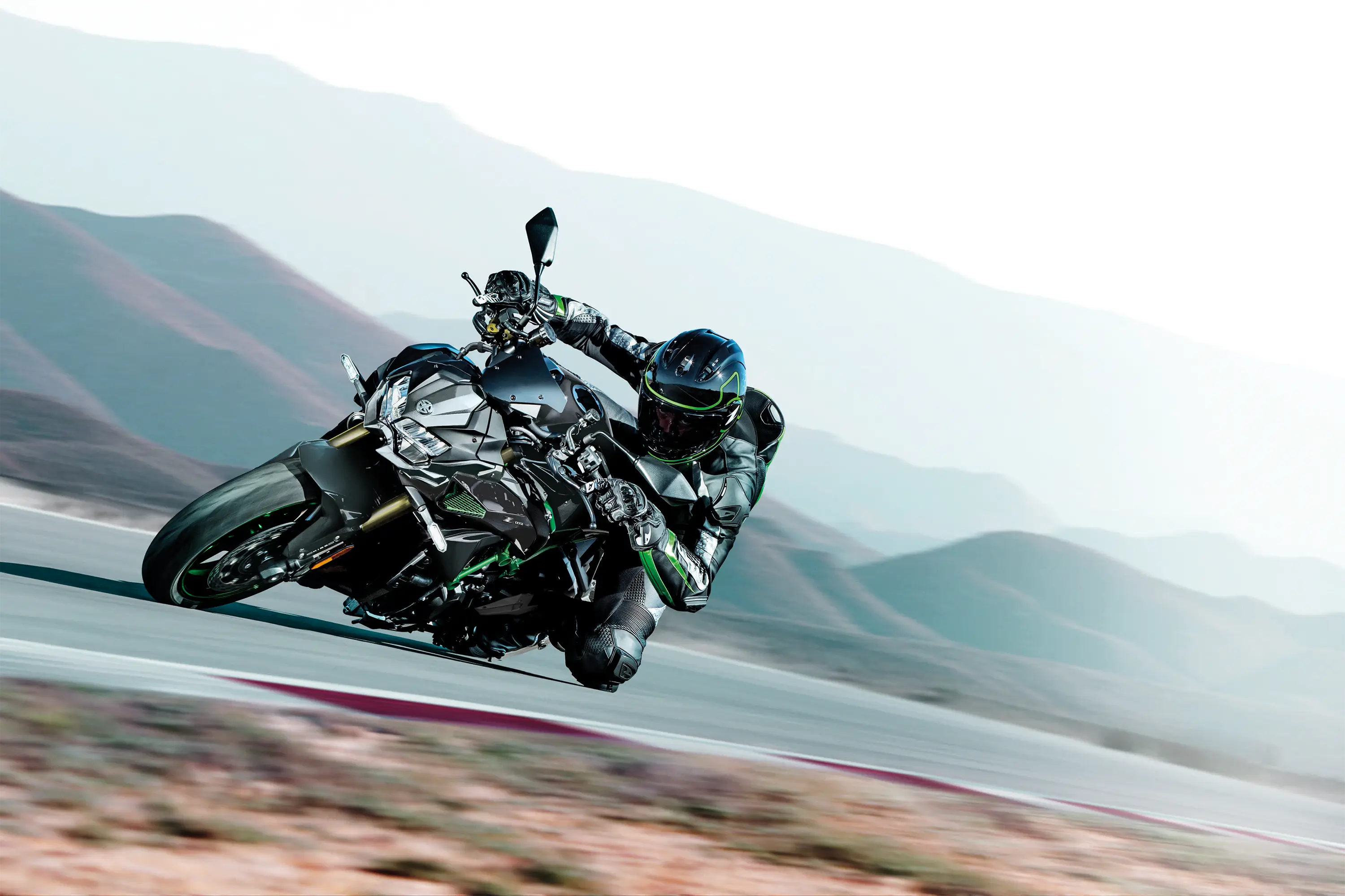 Three-quarter front angle of a person riding a motorcycle turning on a track.
