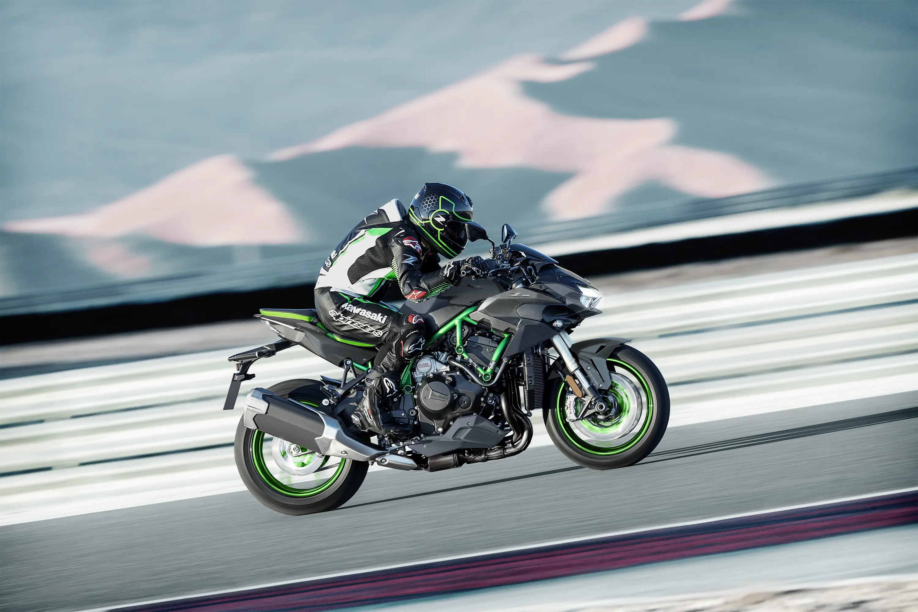 Side angle of a person riding a motorcycle on a track.