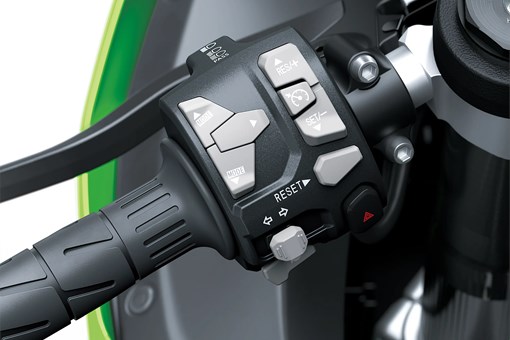 Close-up of the handlebar controls of a motorcycle staged in a white studio background. opens in a new window