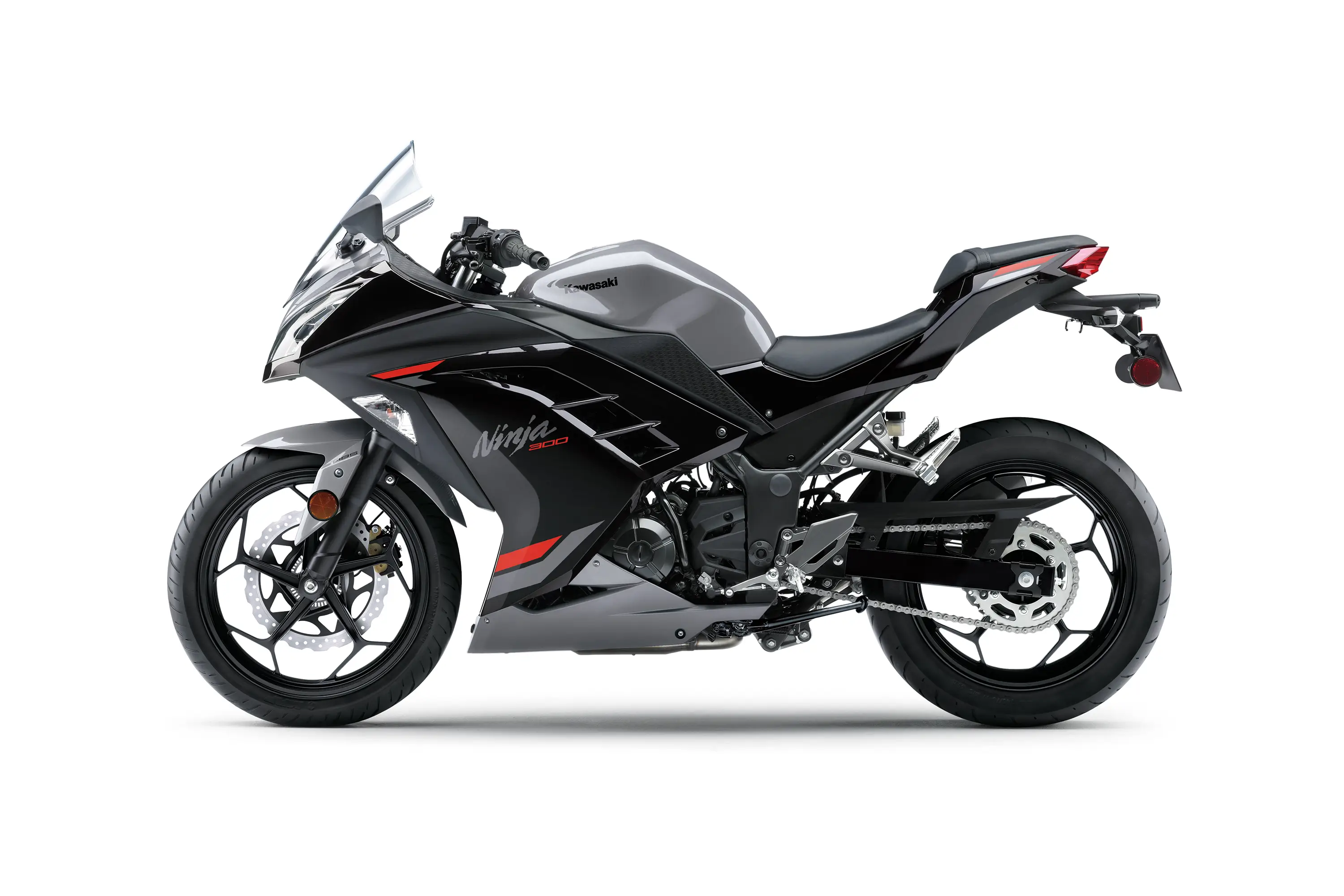Side angle of a grey motorcycle staged in a white studio background.