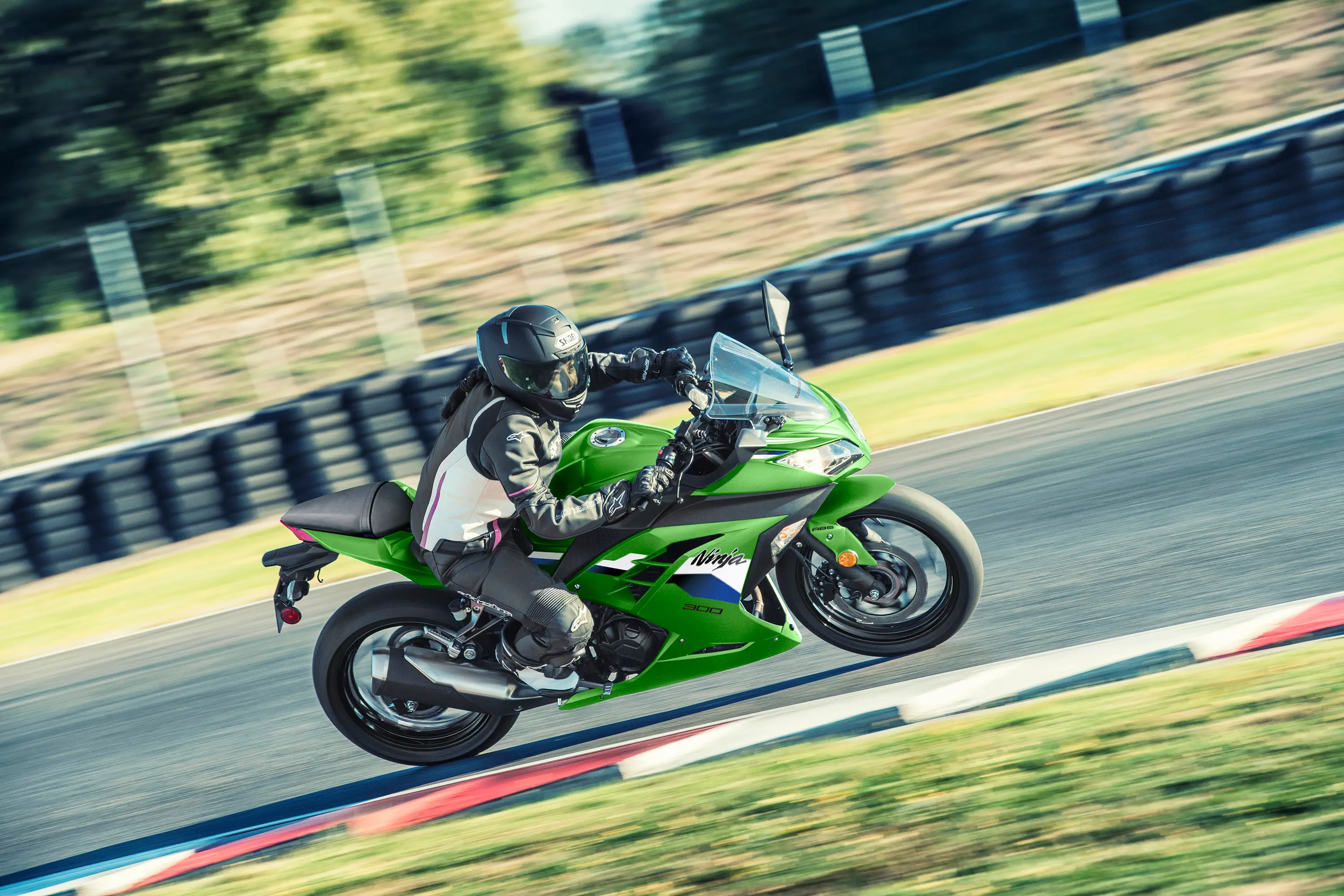 Side angle of a person riding a motorcycle on a track.