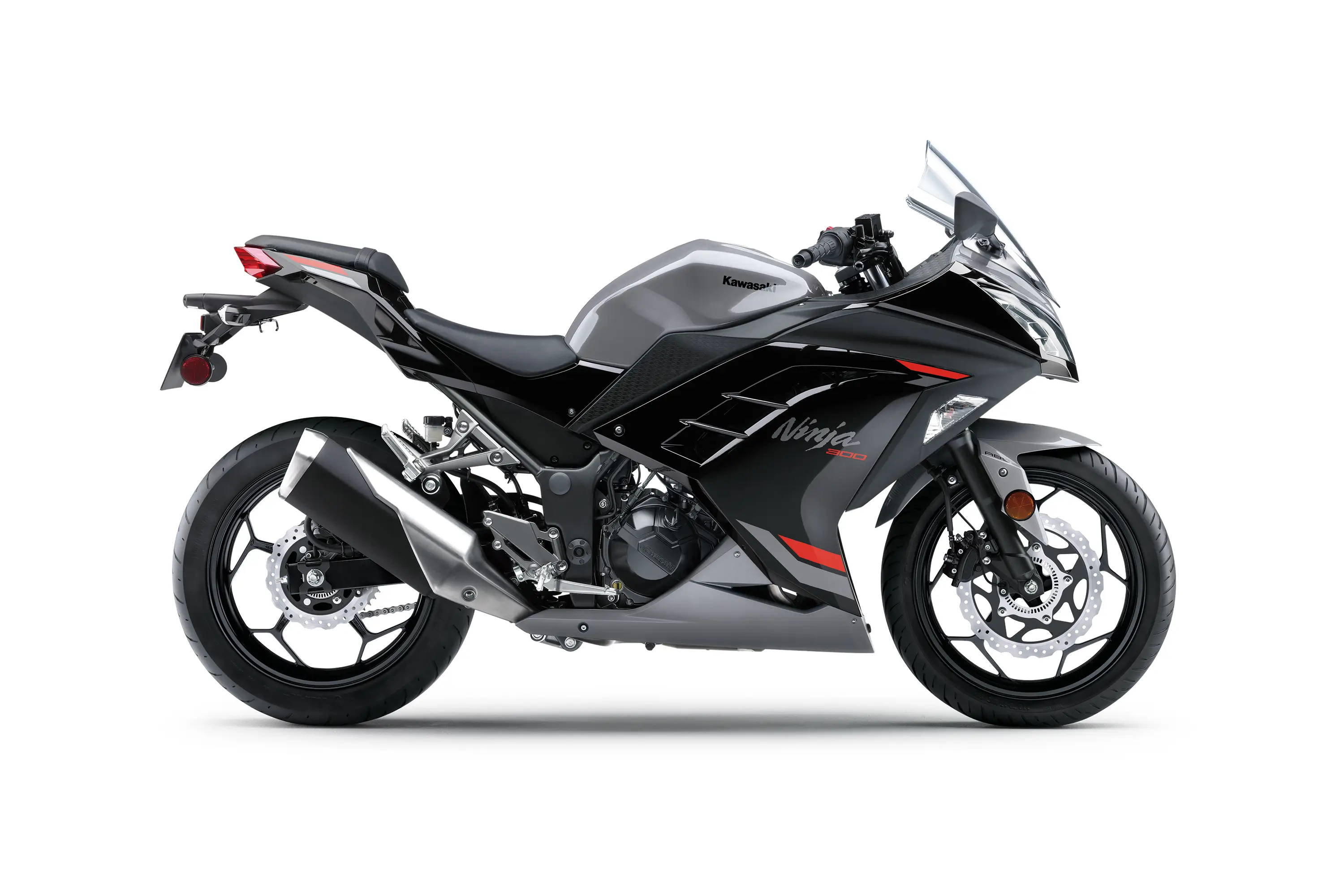 Profile angle of a grey motorcycle staged in a white studio background.