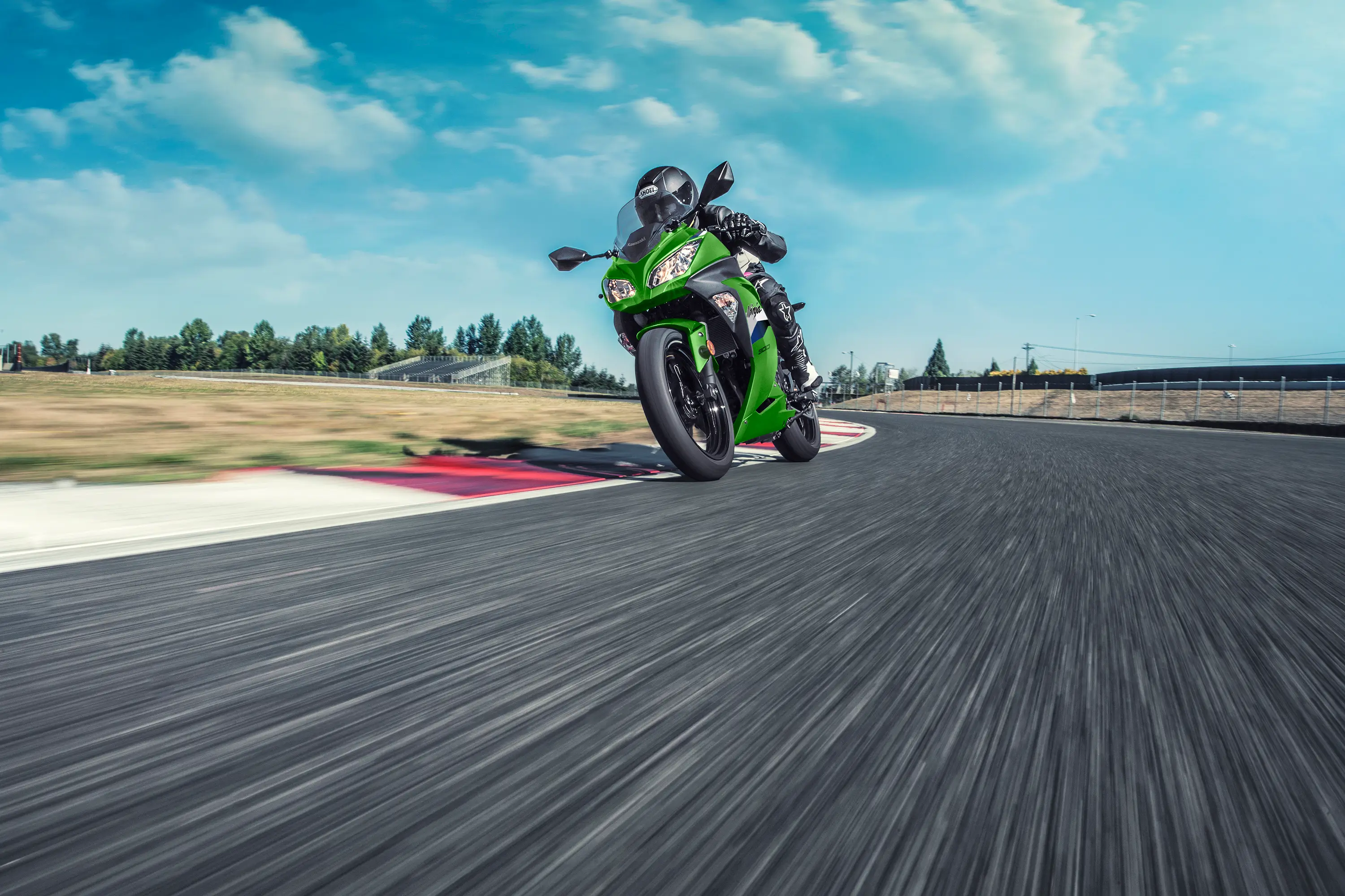 Front angle of a person riding a motorcycle on a track.