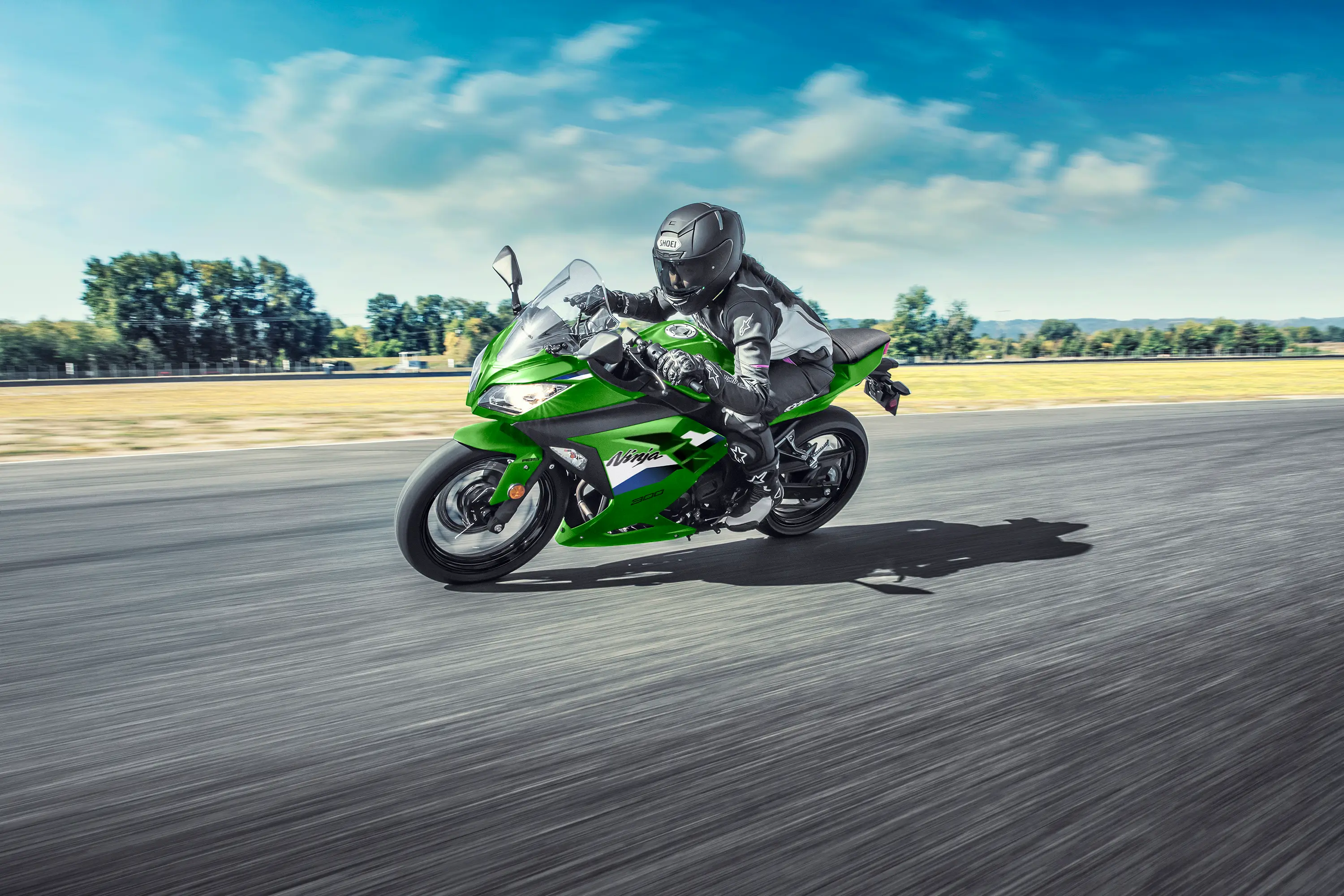 Side angle of a person riding a motorcycle on a track.