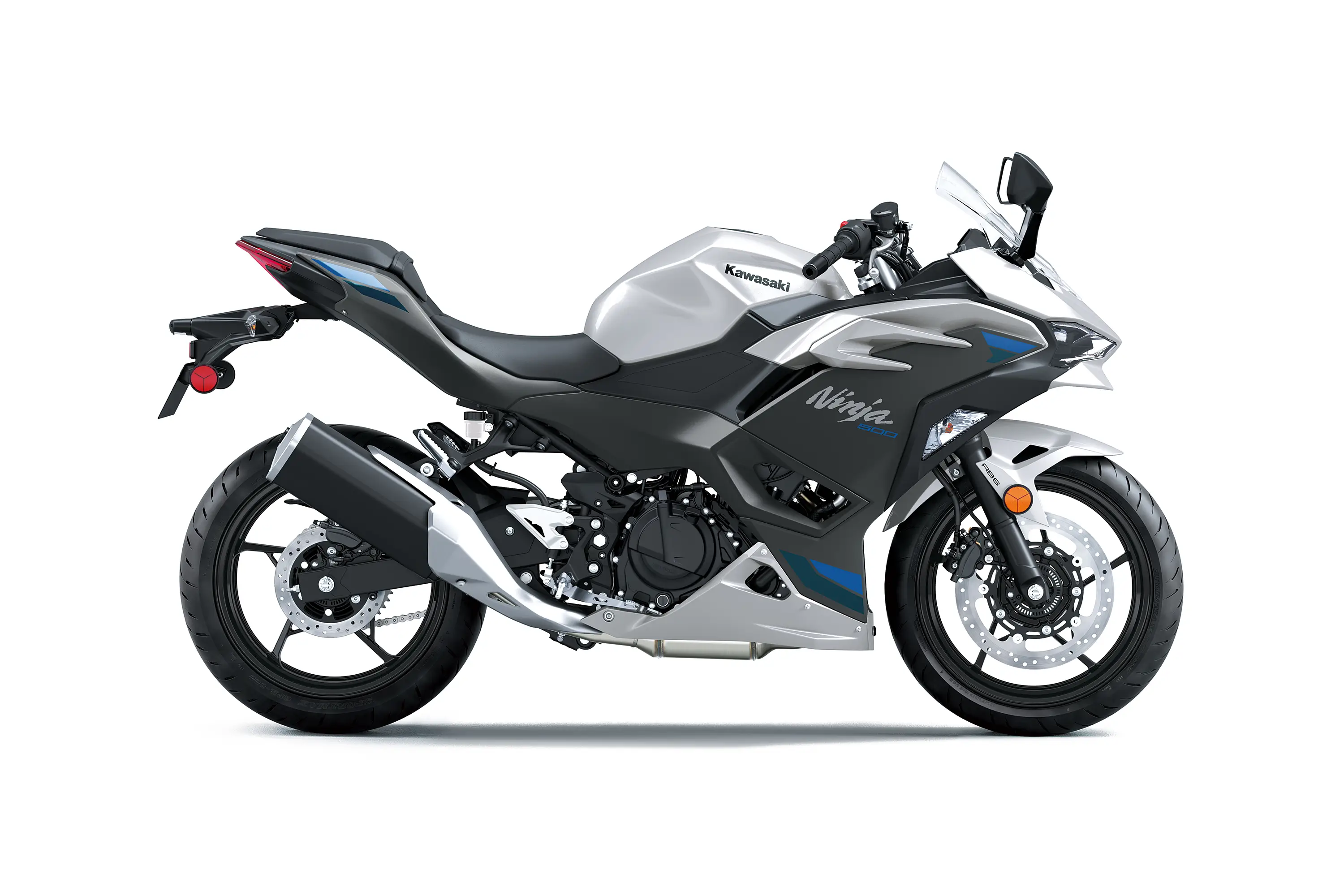 Profile angle of a silver motorcycle staged in a white studio background.