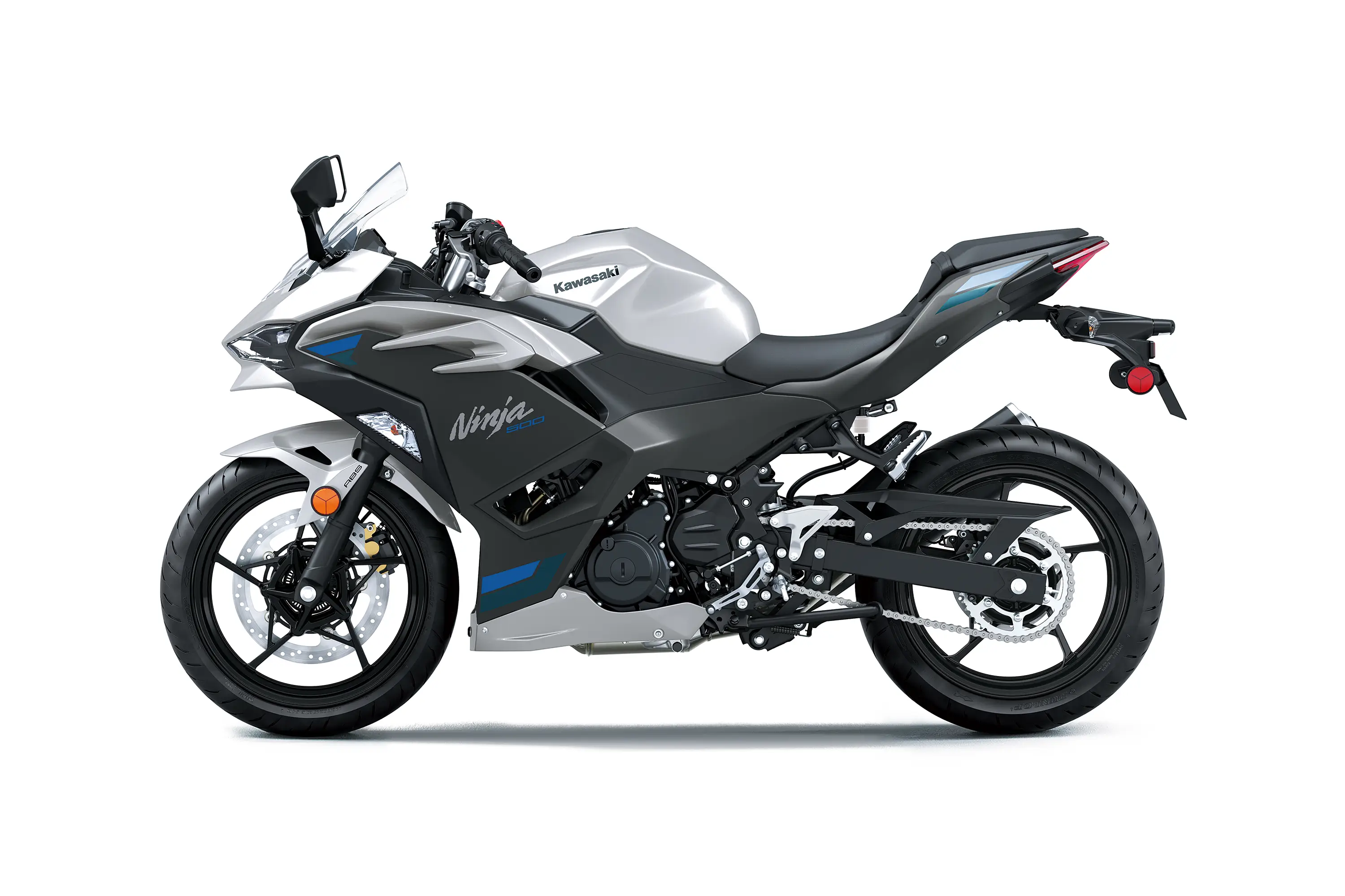 Side angle of a silver motorcycle staged in a white studio background.
