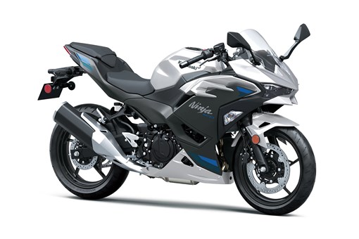 Three-quarter front angle of a silver motorcycle staged in a white studio background. opens in a new window