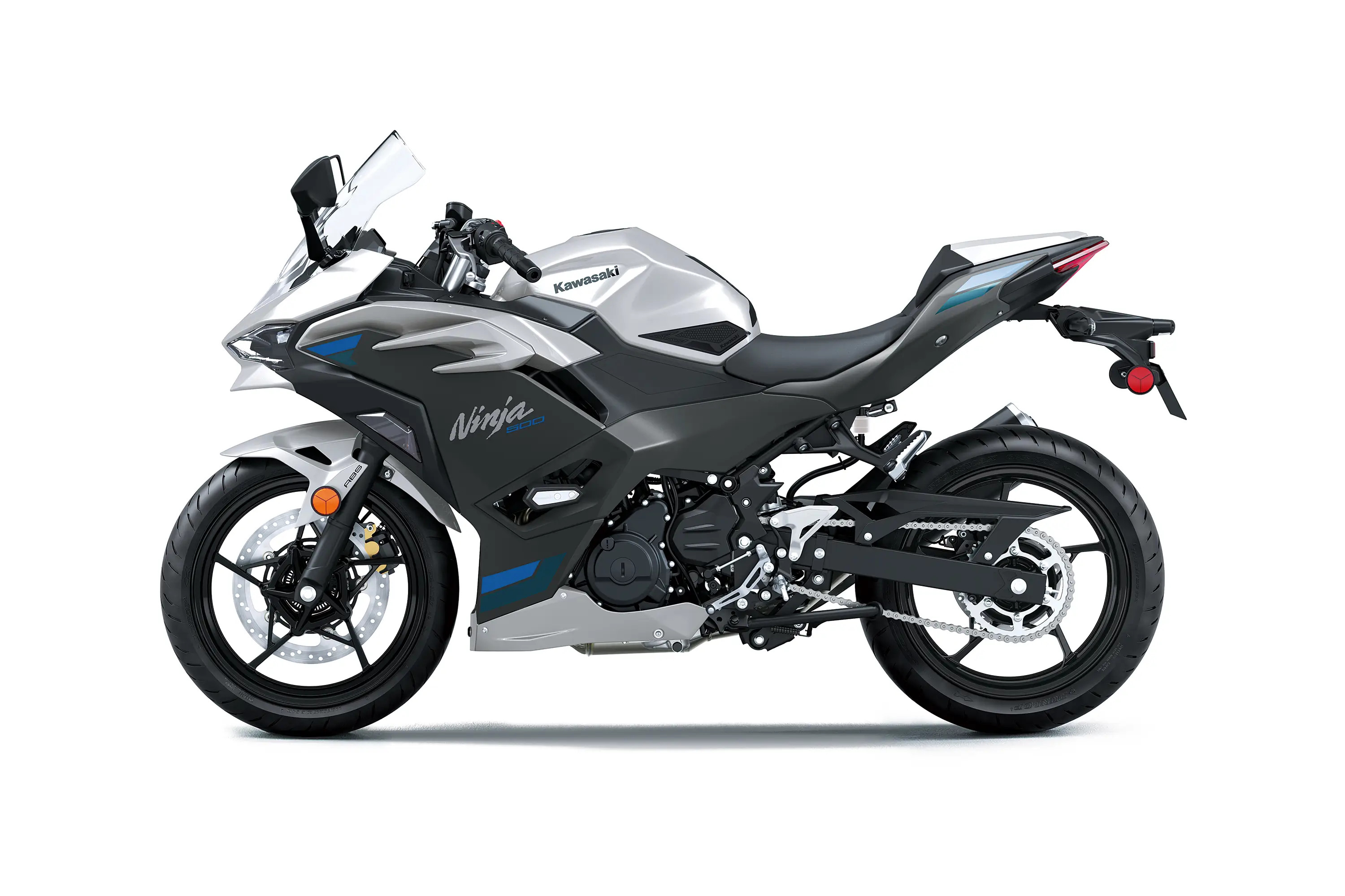 Profile angle of a silver motorcycle staged in a white studio background.