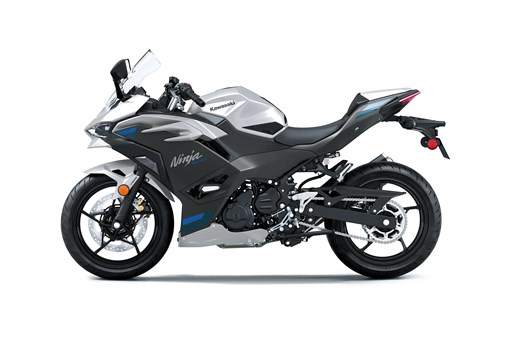 Profile angle of a silver motorcycle staged in a white studio background. opens in a new window