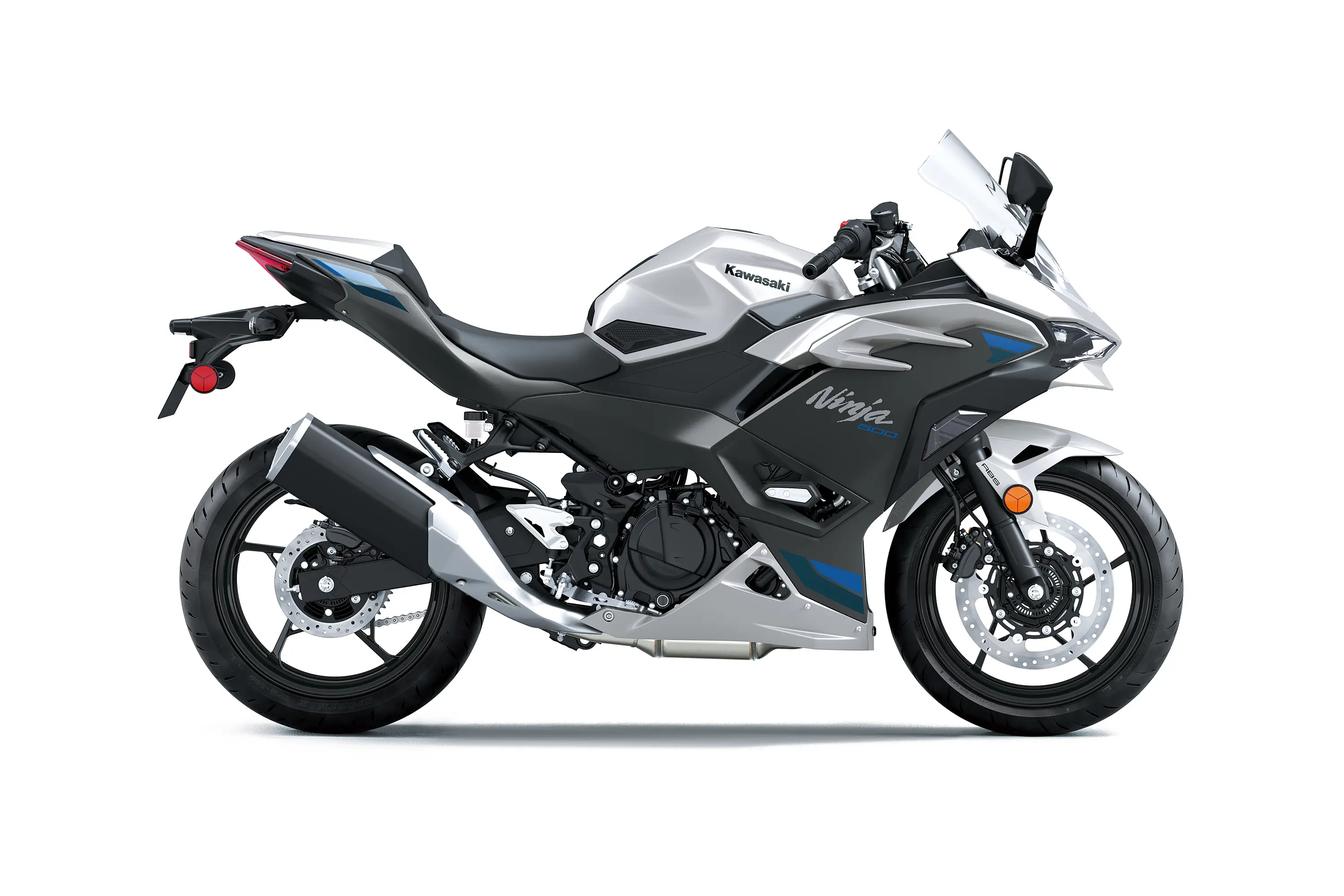 Side angle of a silver motorcycle staged in a white studio background.