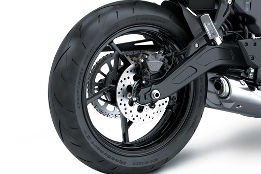 Back wheel of a motorcycle staged in a white studio background. opens in a new window
