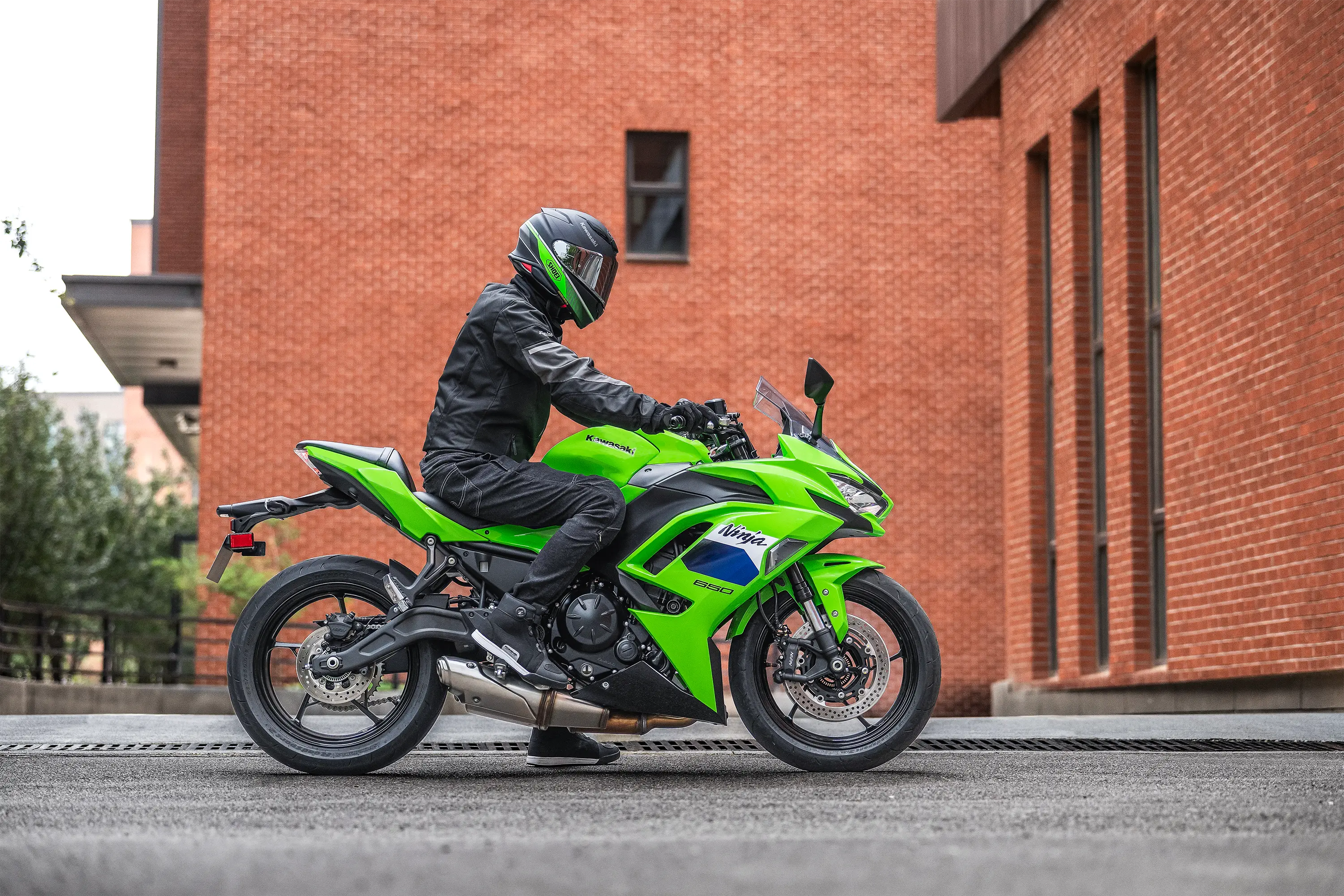 Profile angle of a person parked on a motorcycle on the street.