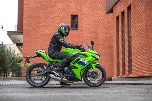 Profile angle of a person parked on a motorcycle on the street. opens in a new window
