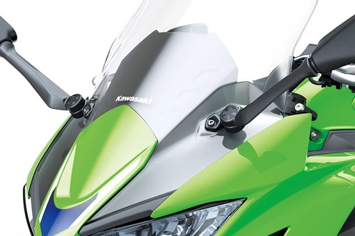 Nose closeup of a motorcycle staged in a white studio background. opens in a new window