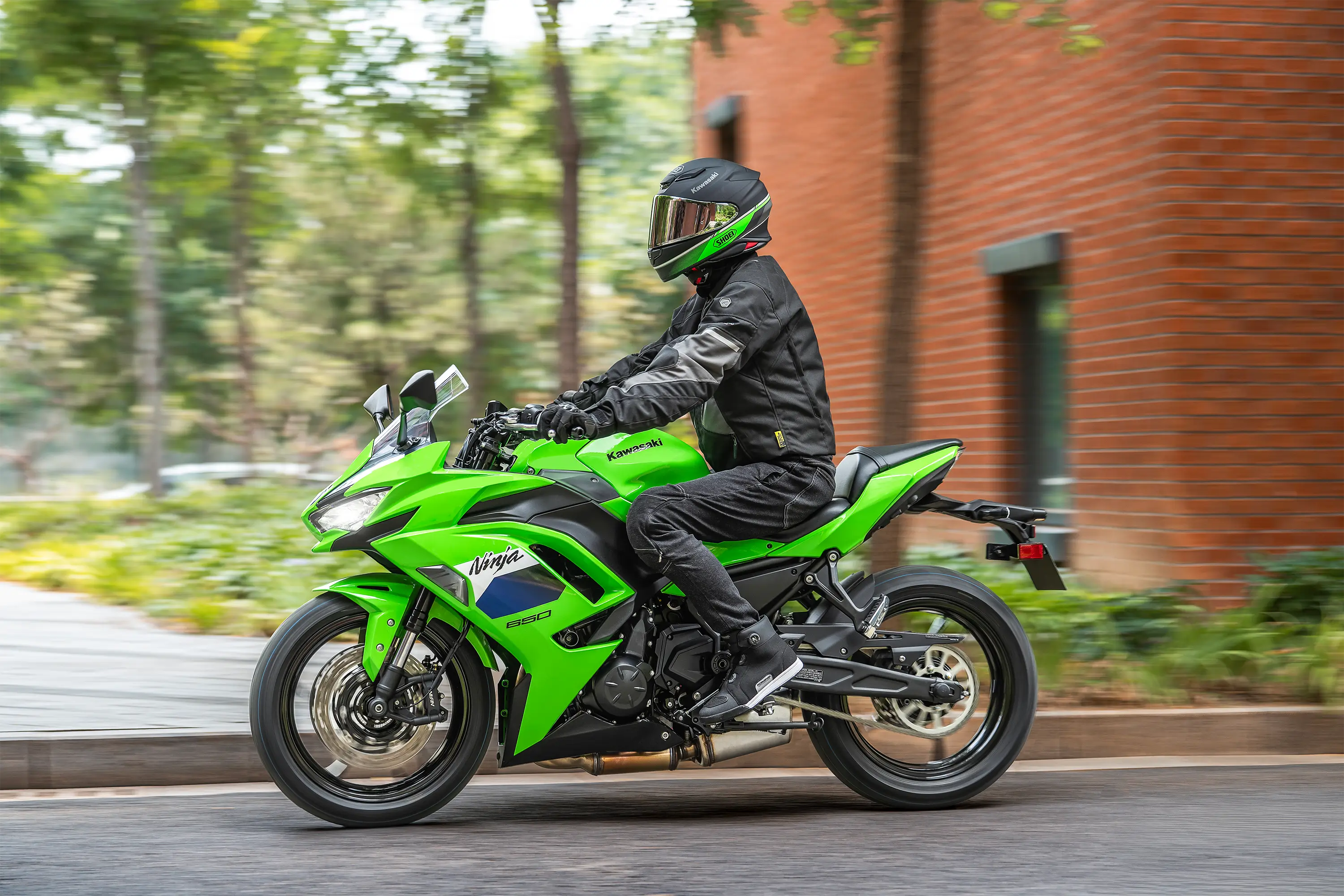 Profile angle of a person riding a motorcycle on the street.
