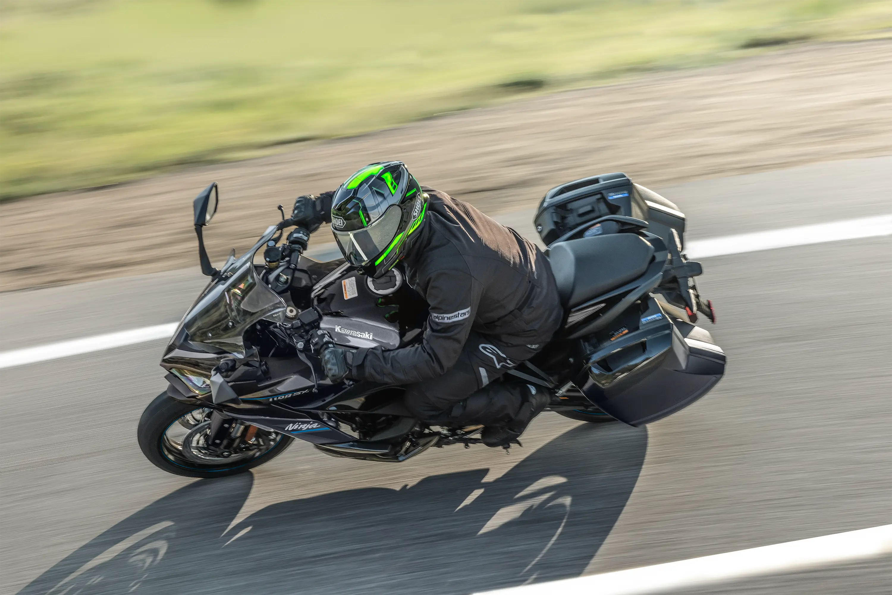 Overhead angle of a person riding a motorcycle on a highway.