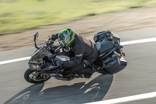 Overhead angle of a person riding a motorcycle on a highway. opens in a new window