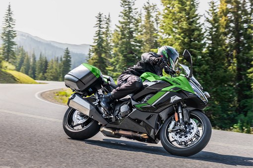 Side angle of a person riding a motorcycle on a highway. opens in a new window