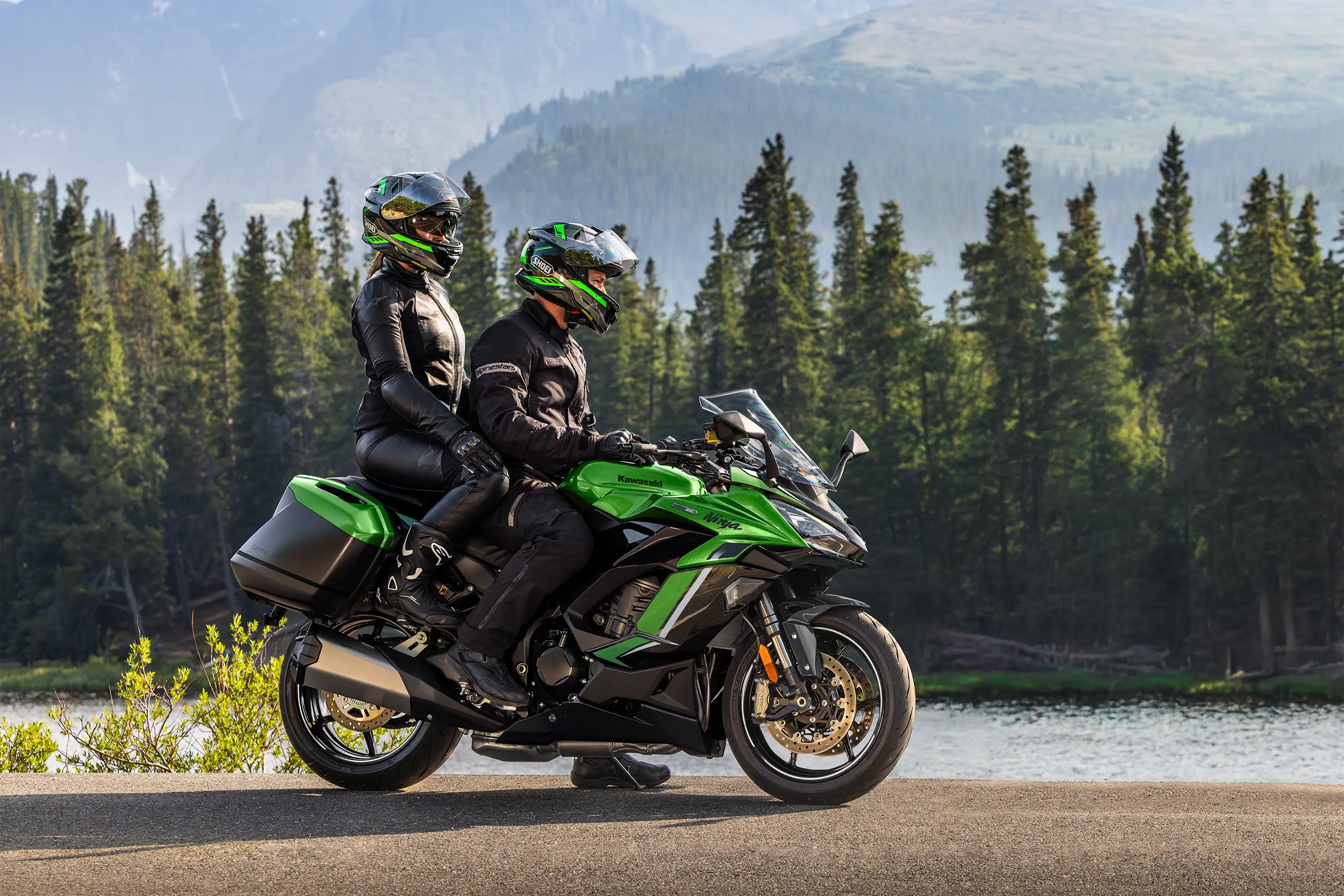 Side angle of a motorcycle parked next to a lake.