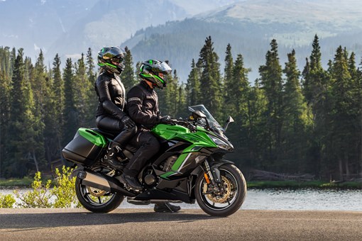 Side angle of a motorcycle parked next to a lake. opens in a new window