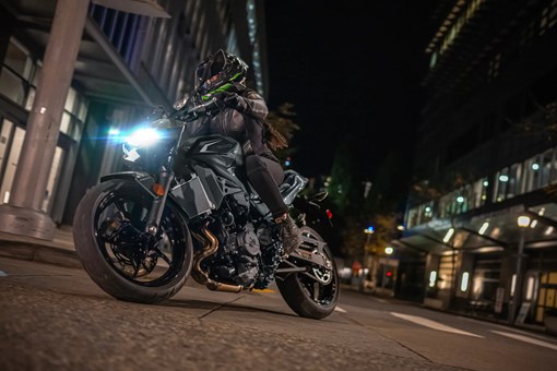 Front angle of a person riding a motorcycle on the street. opens in a new window