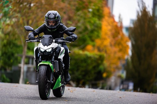 Front angle of a person riding a motorcycle on the street. opens in a new window