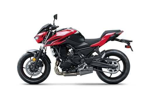 Profile angle of a red motorcycle staged in a white studio background. opens in a new window