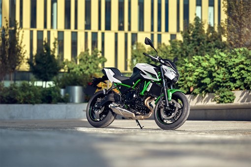 Three-quarter front angle of a white motorcycle parked. opens in a new window