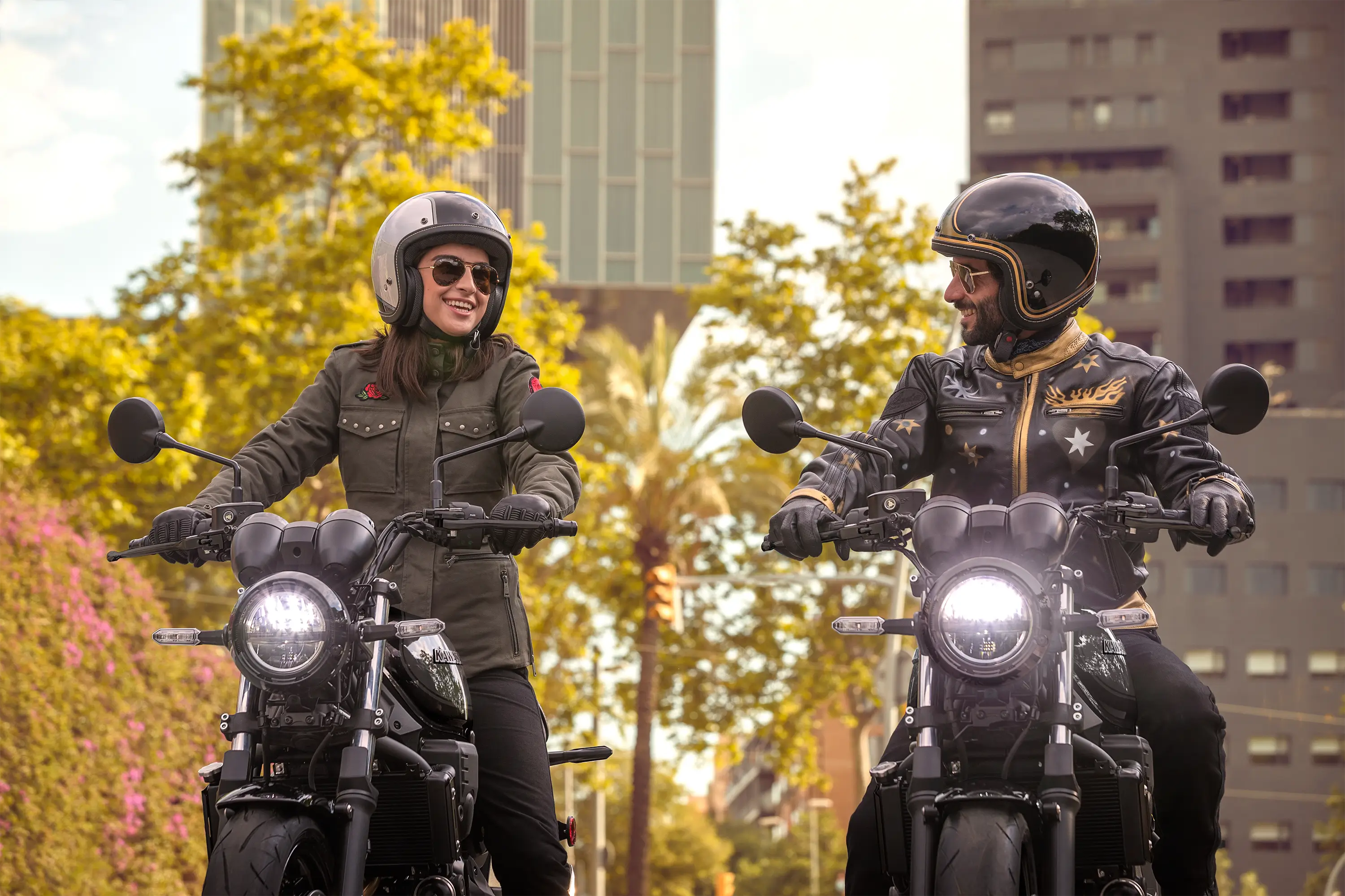 Front angle of people riding a motorcycle on the street.