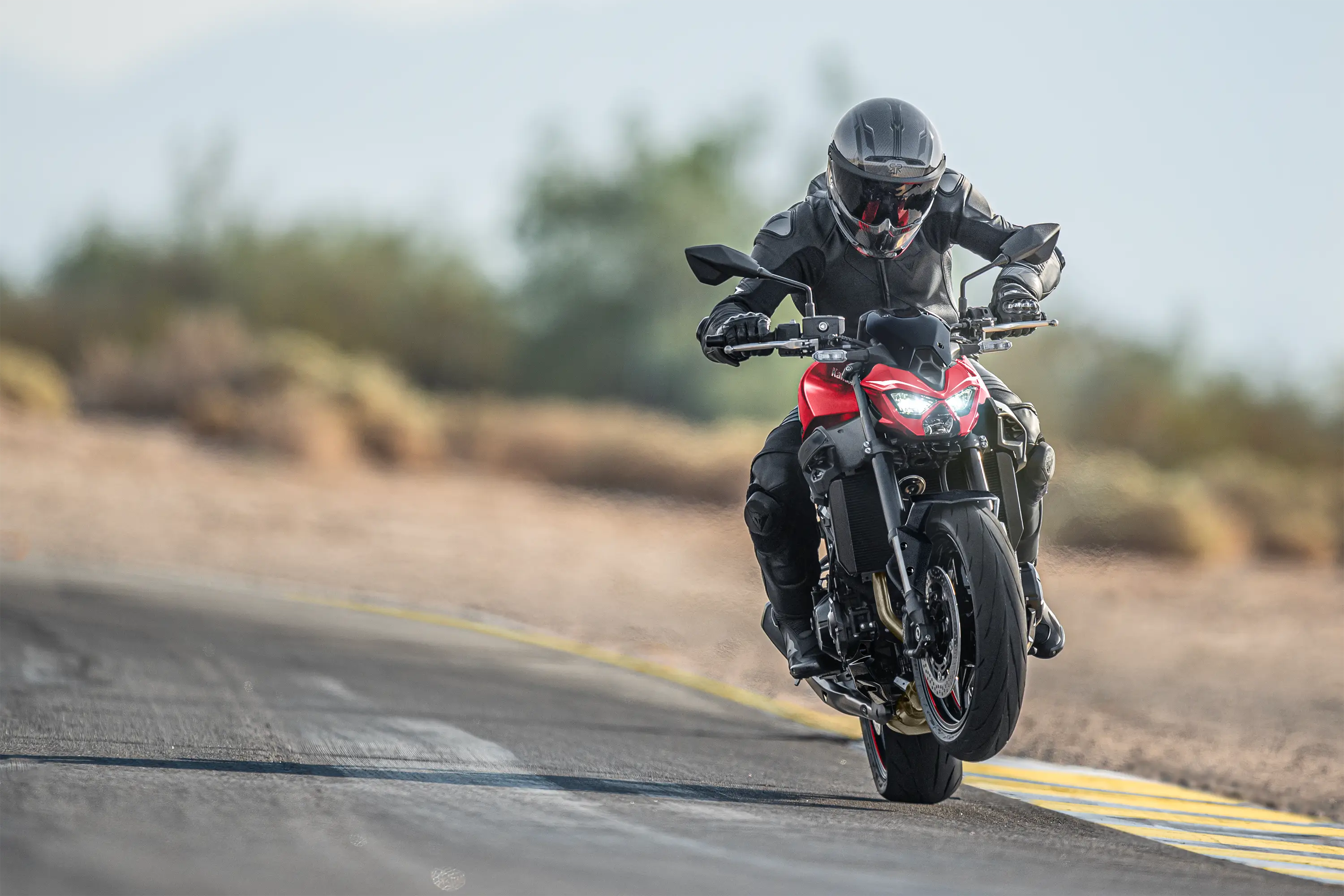 Front angle of a person riding a motorcycle on a highway.