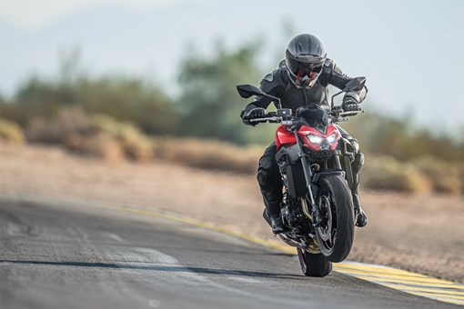 Front angle of a person riding a motorcycle on a highway. opens in a new window
