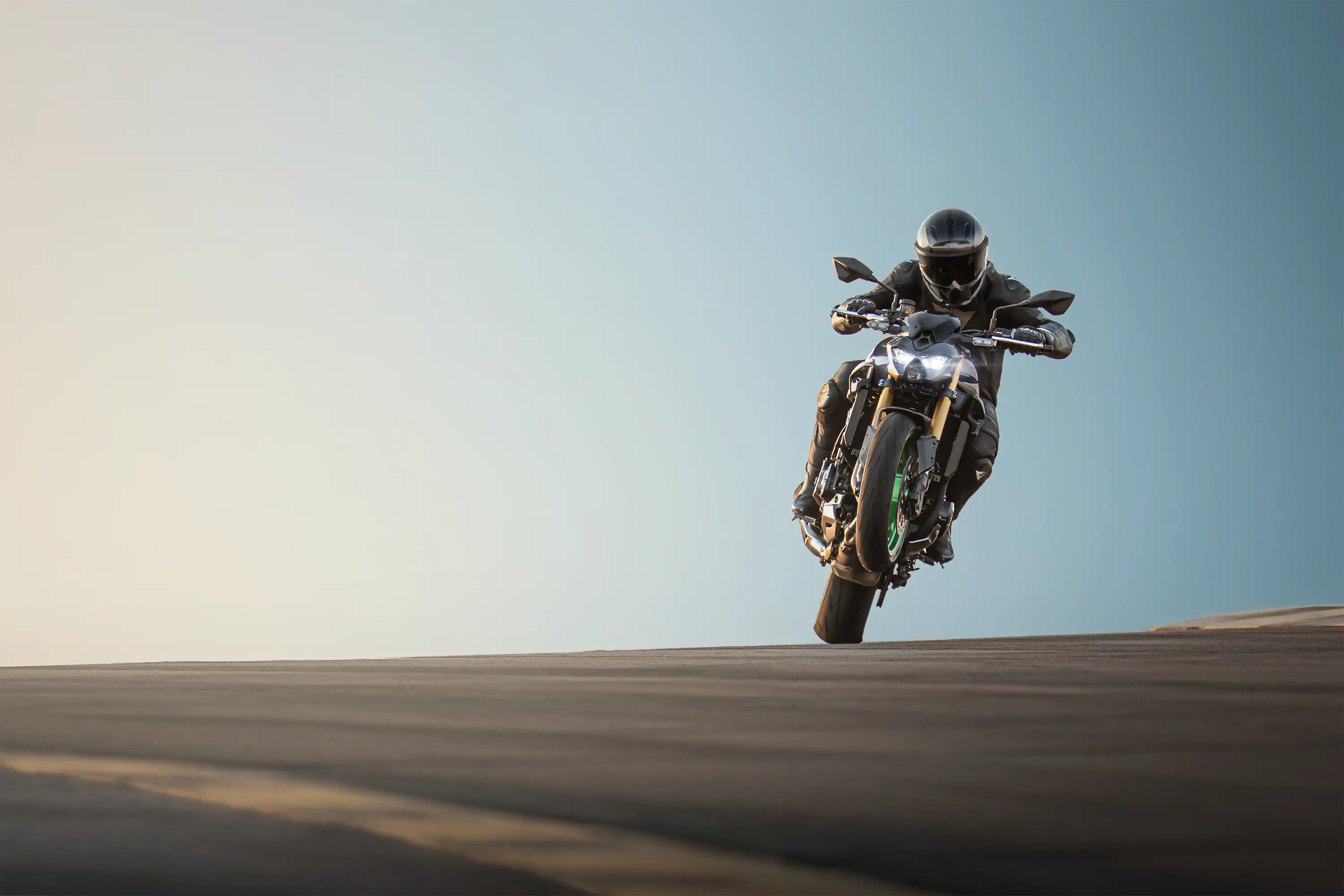 Front angle of a person riding a motorcycle on a track.