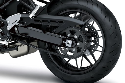 Close-up of the rear tire of a motorcycle staged in a white studio background. opens in a new window
