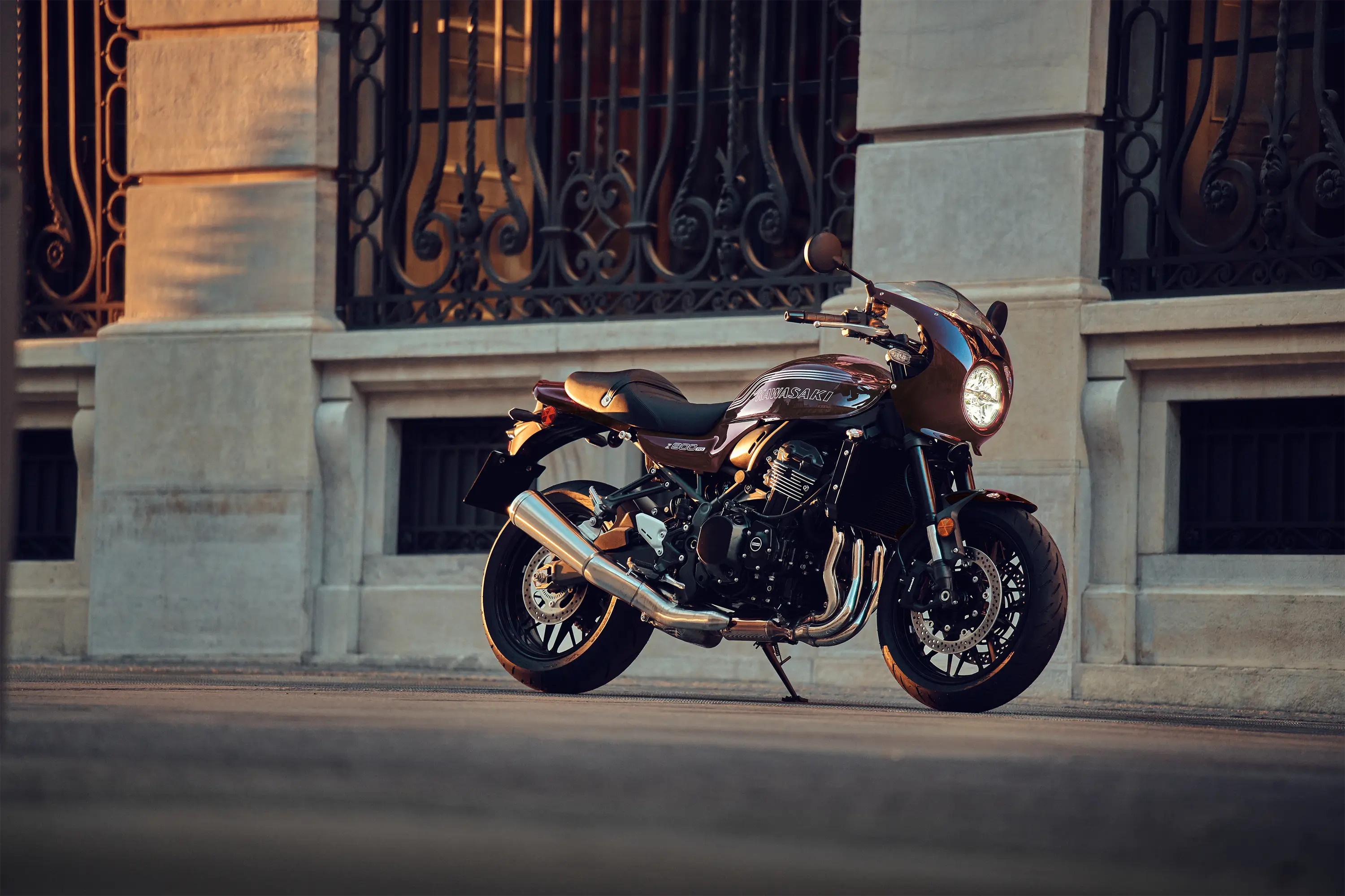 Profile angle of a motorcycle staged on a city sidewalk.