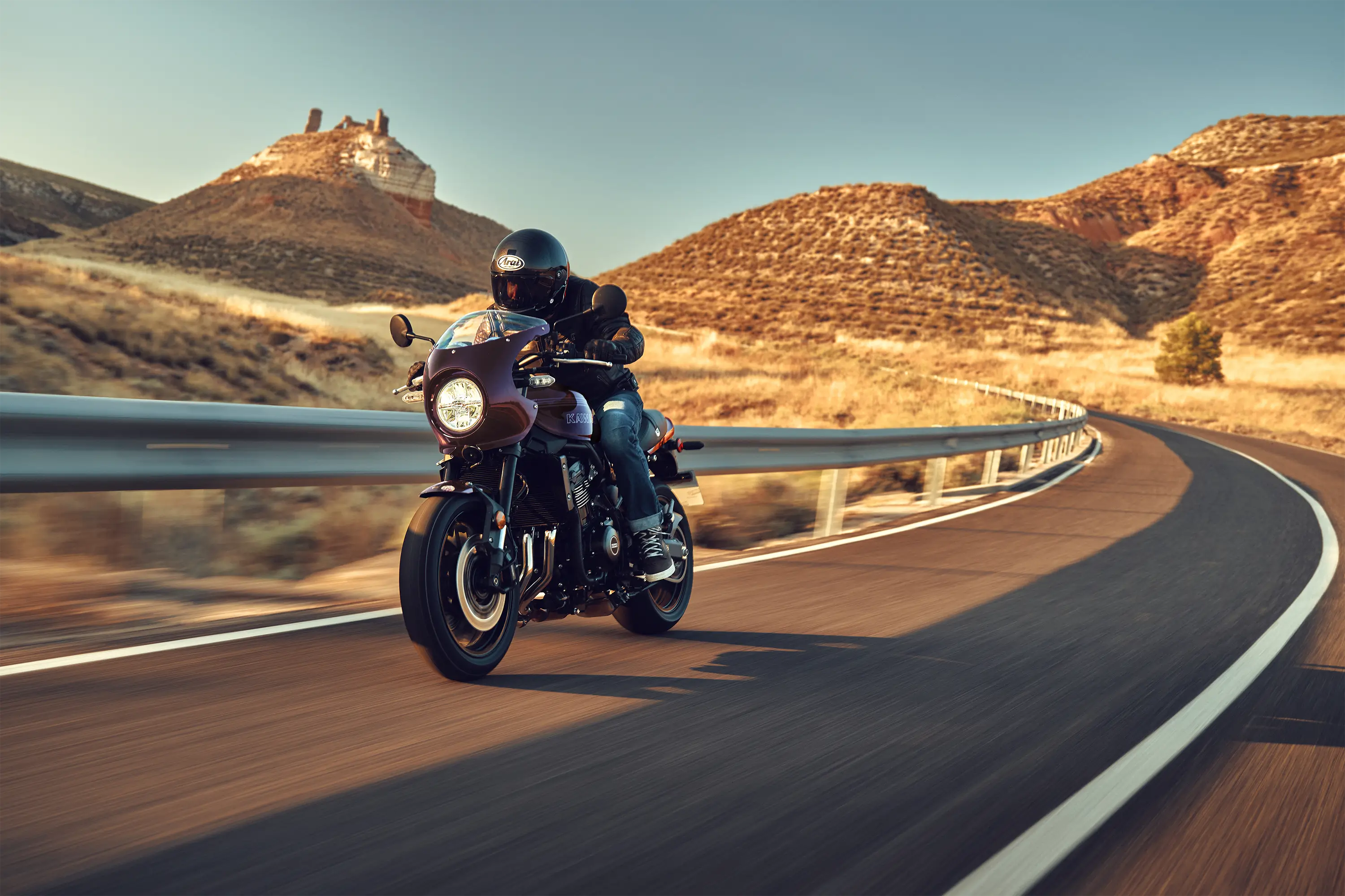 Front angle of a person riding a motorcycle on a highway.