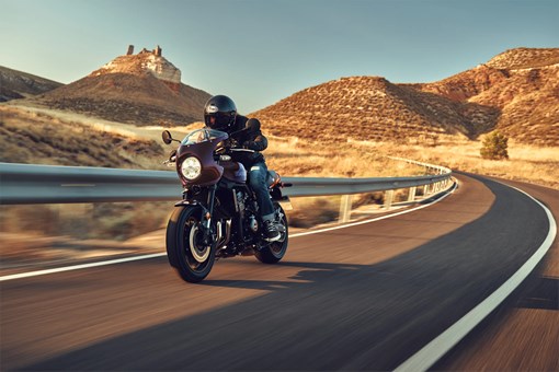 Front angle of a person riding a motorcycle on a highway. opens in a new window